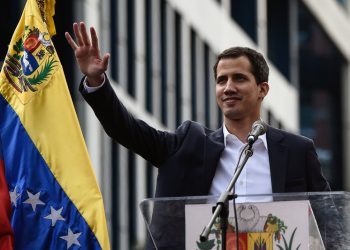Venezuela's National Assembly head Juan Guaidó waves during a mass opposition rally, during which he declared himself the country's acting president on Jan. 23