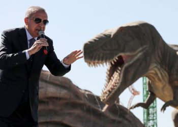 TOPSHOT - Turkish President Recep Tayyip Erdogan delivers a speech next to a model dinosaur during the opening ceremony of the Wonderland Eurasia theme park in Ankara on March 20, 2019. (Photo by Adem ALTAN / AFP)        (Photo credit should read ADEM ALTAN/AFP/Getty Images)