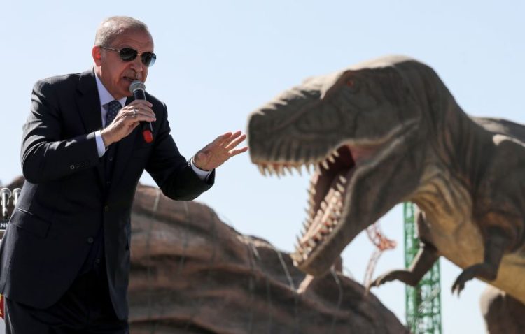 TOPSHOT - Turkish President Recep Tayyip Erdogan delivers a speech next to a model dinosaur during the opening ceremony of the Wonderland Eurasia theme park in Ankara on March 20, 2019. (Photo by Adem ALTAN / AFP)        (Photo credit should read ADEM ALTAN/AFP/Getty Images)