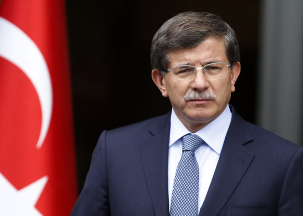 Turkey's Foreign Minister Ahmet Davutoglu addresses the media in Ankara in this June 13, 2013 file photo. Davutoglu said Syria's worsening war now posed a danger to all countries because President Bashar al-Assad's government had been allowed to continue its "crimes" while jihadists from around the world flooded in to fight him. To match Interview SYRIA-CRISIS/TURKEY   REUTERS/Umit Bektas/Files (TURKEY - Tags: POLITICS PROFILE)