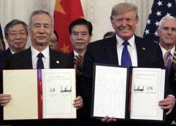 President Donald Trump signs a trade agreement with Chinese Vice Premier Liu He, in the East Room of the White House, Wednesday, Jan. 15, 2020, in Washington. (AP Photo/Evan Vucci)