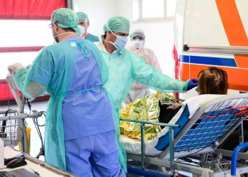 A medical worker wearing a face mask tends to a patient arriving on a stretcher at the new coronavirus intensive care unit of the Brescia Poliambulanza hospital, Lombardy, on March 17, 2020. (Photo by Piero CRUCIATTI / AFP) (Photo by PIERO CRUCIATTI/AFP via Getty Images)