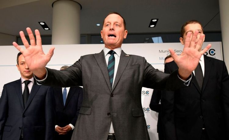 US Ambassador to Germany Richard Grenell (C) gestures during the signing of an agreement between Kosovo and Serbia for railway and street projects at the Munich Security Conference (MSC) in Munich, southern Germany, on February 14, 2020. - The 2020 edition of the Munich Security Conference (MSC) takes place from February 14 to 16, 2020. (Photo by THOMAS KIENZLE / AFP) (Photo by THOMAS KIENZLE/AFP via Getty Images)