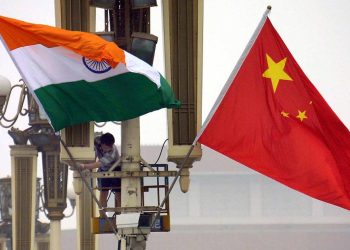 Workers put up the Indian flag (L) alongside the Chinese flag on Tiananmen Square in Beijing, 22 June 2003, ahead of Indian Prime Minister Atal Behari Vajpayee's arrival. Vajpayee's visit is the first to China by an Indian premier in a decade, as the two Asian giants which account for a third of the world's population, have had unsteady relations since a bloody 1962 border war, while fifteen rounds of talks since the 1980s have failed to resolve their boundary disputes.     AFP PHOTO (Photo by - / AFP) (Photo by -/AFP via Getty Images)