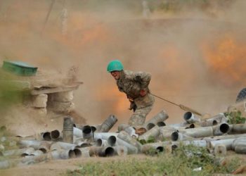 An ethnic Armenian soldier fires an artillery piece during fighting with Azerbaijan's forces in the breakaway region of Nagorno-Karabakh, in this handout picture released September 29, 2020. Defence Ministry of Armenia/Handout via REUTERS  ATTENTION EDITORS - THIS IMAGE HAS BEEN SUPPLIED BY A THIRD PARTY. NO RESALES. NO ARCHIVES. MANDATORY CREDIT. PICTURE WATERMARKED AT SOURCE.