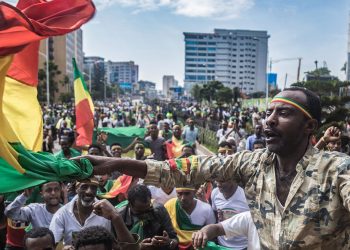 TOPSHOT - Ethiopians wave national flags and celebrate in the streets of Addis Ababa the return of Berhanu Nega, the leader of the former armed movement Ginbot 7, after 11 years in exile, on September 9, 2018. - The popular leader of a formerly outlawed opposition group returned with scores of other senior members of the group after reformist Prime Minister Abiy Ahmed removed the group from a list of "terrorist" organisations in July. Ginbot 7 means "15 May", the date of the Ethiopian general election in 2005, which was marred by protests over alleged fraud that led to the deaths of about 200 people. (Photo by YONAS TADESSE / AFP)        (Photo credit should read YONAS TADESSE/AFP via Getty Images)