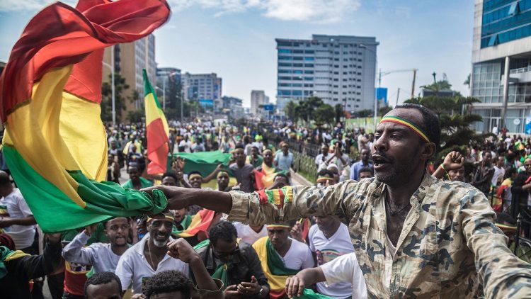 TOPSHOT - Ethiopians wave national flags and celebrate in the streets of Addis Ababa the return of Berhanu Nega, the leader of the former armed movement Ginbot 7, after 11 years in exile, on September 9, 2018. - The popular leader of a formerly outlawed opposition group returned with scores of other senior members of the group after reformist Prime Minister Abiy Ahmed removed the group from a list of "terrorist" organisations in July. Ginbot 7 means "15 May", the date of the Ethiopian general election in 2005, which was marred by protests over alleged fraud that led to the deaths of about 200 people. (Photo by YONAS TADESSE / AFP)        (Photo credit should read YONAS TADESSE/AFP via Getty Images)