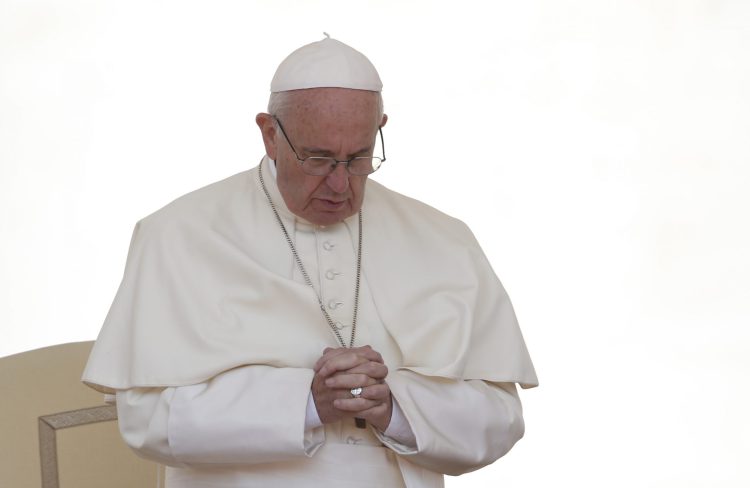 Pope Francis prays as he leads a special audience for military members and their families in St. Peter's Square at the Vatican April 30. (CNS photo/Paul Haring) See POPE-AUDIENCE-RECONCILE May 2, 2016.