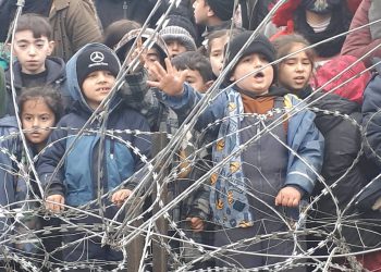 Migrants children gather near the fence on the Poland/Belarus border near Kuznica, Poland, in this video-grab released by the Polish Interior Ministry, November 11, 2021. MON/Handout via REUTERS THIS IMAGE HAS BEEN SUPPLIED BY A THIRD PARTY