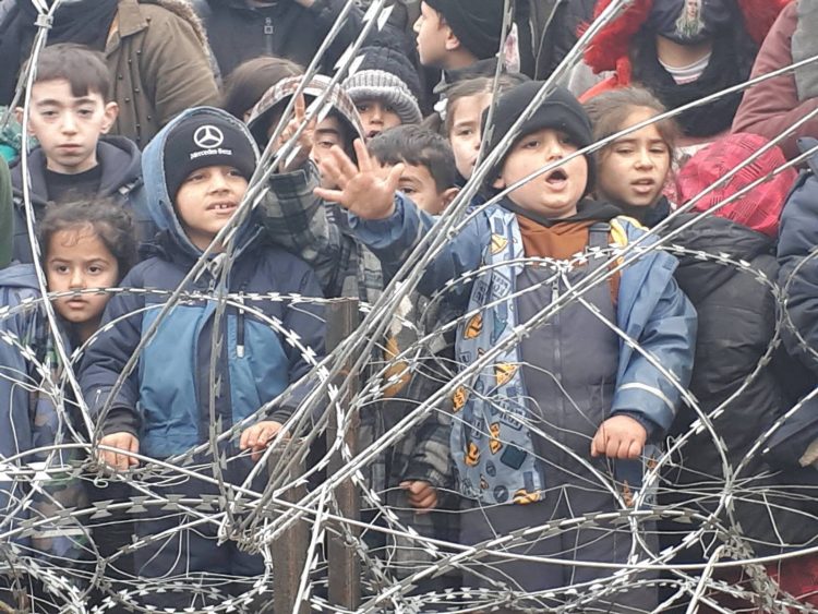 Migrants children gather near the fence on the Poland/Belarus border near Kuznica, Poland, in this video-grab released by the Polish Interior Ministry, November 11, 2021. MON/Handout via REUTERS THIS IMAGE HAS BEEN SUPPLIED BY A THIRD PARTY