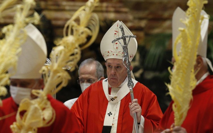 Pope Francis is pictured as cardinals walk in procession at the conclusion of Palm Sunday Mass in St. Peter's Basilica at the Vatican March 28, 2021. (CNS photo/Paul Haring)