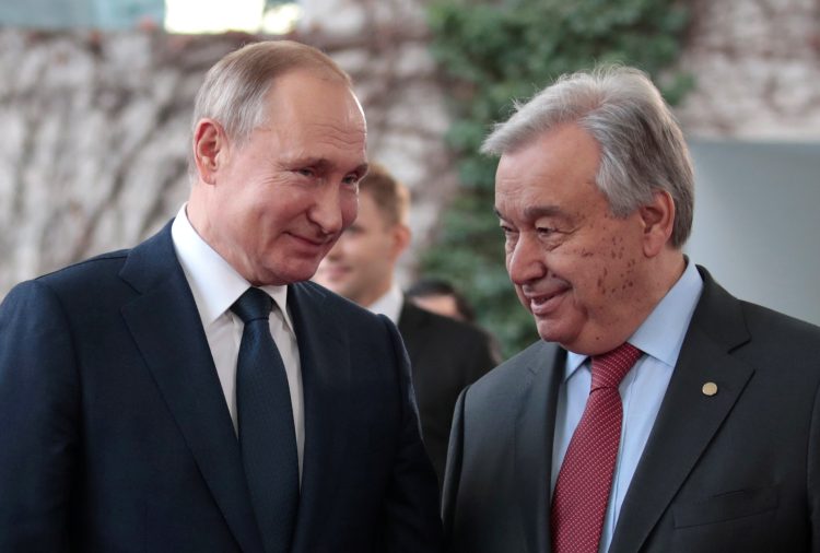 United Nations Secretary-General Antonio Guterres welcomes Russian President Vladimir Putin at the Libya summit in Berlin, Germany, January 19, 2020.  REUTERS/Axel Schmidt