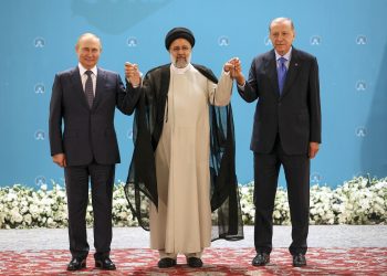 Russian President Vladimir Putin, left, Iranian President Ebrahim Raisi, center, and Turkish President Recep Tayyip Erdogan pose for a photo prior to their talks at the Saadabad palace, in Tehran, Iran, Iran, Tuesday, July 19, 2022. (Sergei Savostyanov, Sputnik, Kremlin Pool Photo via AP)