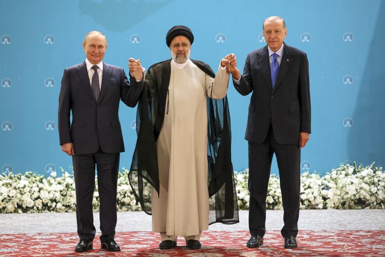 Russian President Vladimir Putin, left, Iranian President Ebrahim Raisi, center, and Turkish President Recep Tayyip Erdogan pose for a photo prior to their talks at the Saadabad palace, in Tehran, Iran, Iran, Tuesday, July 19, 2022. (Sergei Savostyanov, Sputnik, Kremlin Pool Photo via AP)