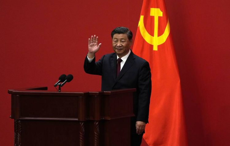 Chinese President Xi Jinping waves at an event to introduce new members of the Politburo Standing Committee at the Great Hall of the People in Beijing, Sunday, Oct. 23, 2022. (AP Photo/Andy Wong)