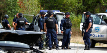 Police officers stand guard in the aftermath of a shooting, near the village of Zvecane, Kosovo September 24, 2023. REUTERS/Ognen Teofilovski