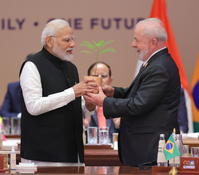 India's Prime Minister Narendra Modi (L) presents a sapling to Brazil's President Luiz Inacio Lula da Silva (R) during the third working session of the G20 Leaders' Summit in New Delhi on September 10, 2023.  - RESTRICTED TO EDITORIAL USE
 (Photo by PIB / AFP) / RESTRICTED TO EDITORIAL USE