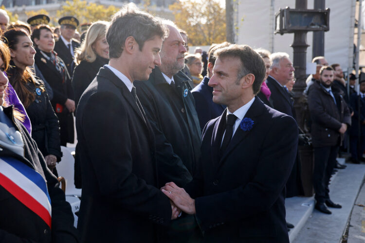 French President Emmanuel Macron (R) shakes hands with French Education and Youth Minister Gabriel Attal (L) during a ceremony at the Tomb of the Unknown Soldier at the Arc de Triomphe in Paris on November 11, 2023, as part of commemorations marking the 105th anniversary of the November 11, 1918 Armistice, ending World War I (WWI). (Photo by Ludovic MARIN / POOL / AFP) (Photo by LUDOVIC MARIN/POOL/AFP via Getty Images)