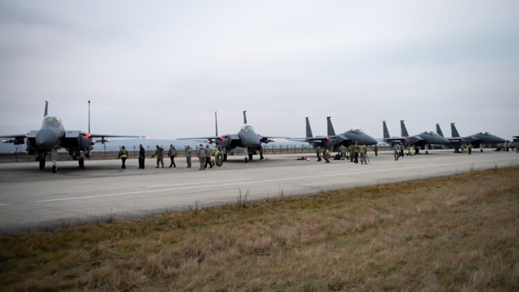 F-15E Strike Eagles with the 336th Fighter Squadron park on the ramp at Campia Turzii, Romania, in support of NATO Enhanced Air Policing mission, Dec. 15, 2021 Campia Turzii, Romania, in support of NATO Enhanced Air Policing, Dec. 15, 2021. U.S. European Command supports NATO allies and partners to strengthen deterrence efforts and adapt through improving readiness and responsiveness as a coalition force. (U.S. Air Force photo by Airman 1st Class Cedrique Oldaker)