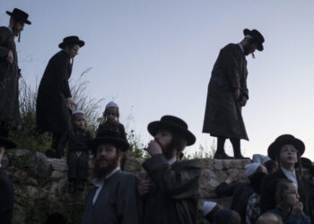 Ultra-Orthodox Jewish men and youth gather to collect water to make matzoh, a traditional handmade unleavened bread for the holiday of Passover, during the Maim Shelanu ceremony at a mountain spring in the outskirts of Jerusalem, Sunday, April 21, 2024. (AP Photo/Leo Correa)