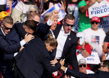 Republican presidential candidate and former U.S. President Donald Trump is assisted by U.S. Secret Service personnel after gunfire rang out during a campaign rally at the Butler Farm Show in Butler, Pennsylvania, U.S., July 13, 2024. REUTERS/Brendan McDermid