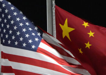 FILE - The American and Chinese flags wave at Genting Snow Park ahead of the 2022 Winter Olympics, Feb. 2, 2022, in Zhangjiakou, China. As President Joe Biden and Chinese leader Xi Jinping prepare to meet at the upcoming Asia-Pacific Economic Cooperation summit in San Francisco, basic information has remained guarded. That could ratchet up the pressure on how each side negotiates, down to the smallest detail. (AP Photo/Kiichiro Sato, File)