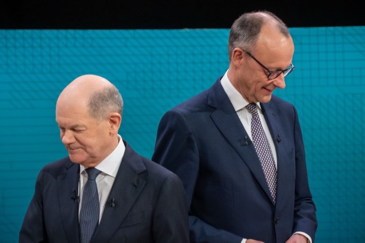 09 February 2025, Berlin: German Chancellor and top candidate of the Social Democratic Party (SPD), Olaf Scholz (L), and Friedrich Merz, Chairman and top candidate of the Christian Democratic Union (CDU), take the podiums at the start of the first debate of the Bundestag election campaigns, at the ARD and ZDF television broadcasters studio. German Chancellor Olaf Scholz and his conservative rival Friedrich Merz face off in a live TV debate, exactly two weeks before the country heads to the polls. Photo: Michael Kappeler/dpa-Pool/dpa