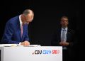 05 May 2025, Berlin: Christian Democratic Union (CDU) Chairman and candidate for Chancellor Friedrich Merz signs the coalition agreement between the CDU, Christian Social Union and Social Democratic Party. Photo: Bernd von Jutrczenka/dpa