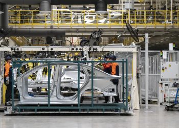 Employees in the body welding shop on the production line of the Geely Automobile Holdings' Changxing production base in Changxing, China, on Friday, June 13, 2025. China's EV industry is in the throes of a vicious price war, sending share prices tumbling and prompting government intervention to try and prop up the market. Photographer: Qilai Shen/Bloomberg