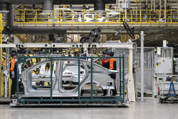 Employees in the body welding shop on the production line of the Geely Automobile Holdings' Changxing production base in Changxing, China, on Friday, June 13, 2025. China's EV industry is in the throes of a vicious price war, sending share prices tumbling and prompting government intervention to try and prop up the market. Photographer: Qilai Shen/Bloomberg