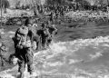 U.S. reinforcements wade through the surf as they land at Normandy in the days following the Allies' June 1944, D-Day invasion of occupied France. (AP Photo)