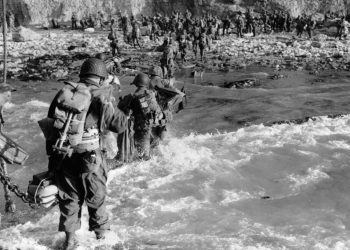 U.S. reinforcements wade through the surf as they land at Normandy in the days following the Allies' June 1944, D-Day invasion of occupied France. (AP Photo)