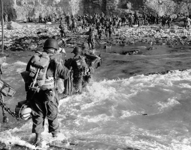 U.S. reinforcements wade through the surf as they land at Normandy in the days following the Allies' June 1944, D-Day invasion of occupied France. (AP Photo)