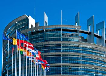 The European Parliament building in Strasbourg, France with flags waving calmly celebrating peace of the Europe. July 12, 2020.