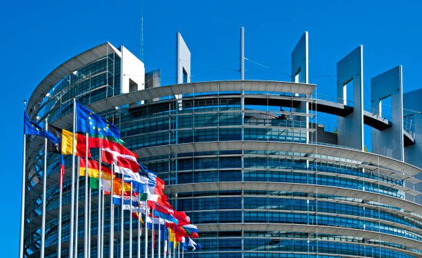 The European Parliament building in Strasbourg, France with flags waving calmly celebrating peace of the Europe. July 12, 2020.