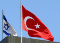 FILE PHOTO: A Turkish flag flutters atop the Turkish embassy as an Israeli flag is seen nearby, in Tel Aviv, Israel June 26, 2016.  REUTERS/Baz Ratner/File Photo
