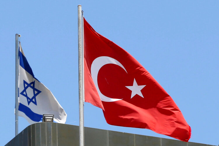 FILE PHOTO: A Turkish flag flutters atop the Turkish embassy as an Israeli flag is seen nearby, in Tel Aviv, Israel June 26, 2016.  REUTERS/Baz Ratner/File Photo