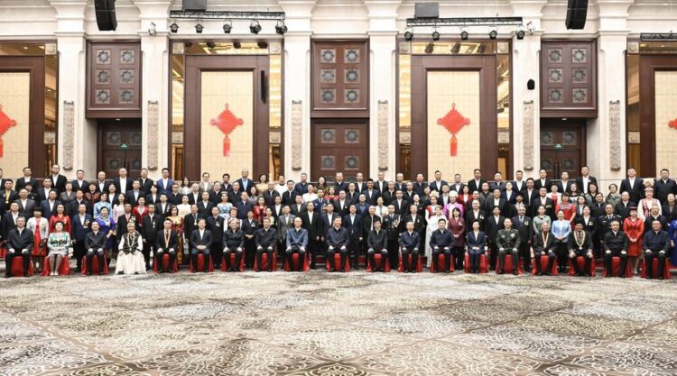 (250923) -- URUMQI, Sept. 23, 2025 (Xinhua) -- Chinese President Xi Jinping, also general secretary of the Communist Party of China Central Committee and chairman of the Central Military Commission, poses for a group photo while meeting with representatives from all ethnic groups and all walks of life in northwest China's Xinjiang Uygur Autonomous Region, in Urumqi, the regional capital, Sept. 23, 2025. (Xinhua/Yan Yan)