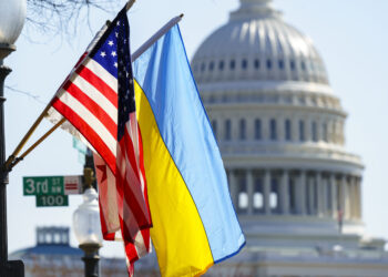 The flags of Ukraine, the United States, and the District of Columbia fly together on Pennsylvania Avenue near the Capitol, Saturday, March 5, 2022, by order of the mayor of Washington. (AP Photo/J. Scott Applewhite)