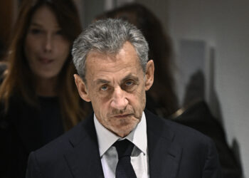(FILES) Former French president Nicolas Sarkozy leaves in front of his wife French-Italian singer Carla Bruni after the verdict in his trial for illegal campaign financing from Libya for his successful 2007 presidential bid, at the Tribunal de Paris courthouse in Paris, on September 25, 2025. On November 10, 2025, the Paris Court of Appeal ordered the release of former French President Nicolas Sarkozy, who had been imprisoned for 20 days following his conviction in the case of Libyan funding of his 2007 presidential campaign, and placed him under judicial supervision. (Photo by JULIEN DE ROSA / AFP) (Photo by JULIEN DE ROSA/AFP via Getty Images)