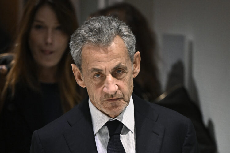(FILES) Former French president Nicolas Sarkozy leaves in front of his wife French-Italian singer Carla Bruni after the verdict in his trial for illegal campaign financing from Libya for his successful 2007 presidential bid, at the Tribunal de Paris courthouse in Paris, on September 25, 2025. On November 10, 2025, the Paris Court of Appeal ordered the release of former French President Nicolas Sarkozy, who had been imprisoned for 20 days following his conviction in the case of Libyan funding of his 2007 presidential campaign, and placed him under judicial supervision. (Photo by JULIEN DE ROSA / AFP) (Photo by JULIEN DE ROSA/AFP via Getty Images)