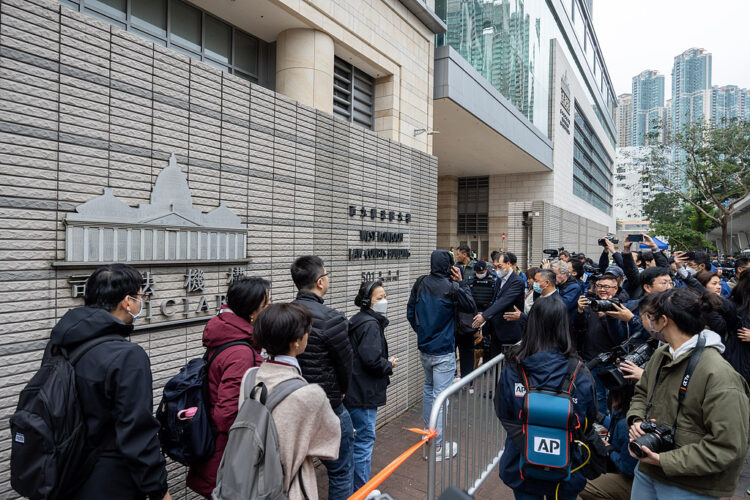 Members of the public wait to enter the West Kowloon Magistrates' Courts ahead of a hearing for former media mogul Jimmy Lai in Hong Kong, China, on Monday, Dec. 18, 2023. After more than 1,000 days in prison, the biggest target in Hong Kong's crackdown on dissent, Lai, will finally go on trial this week in a case closely scrutinized by Western governments. Photographer: Paul Yeung/Bloomberg
