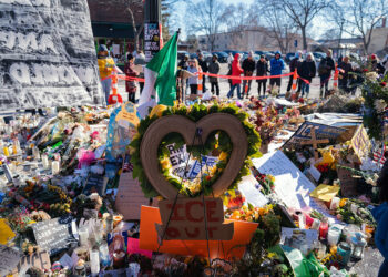 An "ICE Out" sign at a memorial for Alex Pretti near the scene of a fatal shooting by federal law enforcement officers in Minneapolis, Minnesota, US, on Thursday, Jan. 29, 2026. White House Border Czar Tom Homan said the Trump administration will scale down operations in Minnesota and conduct targeted anti-immigration actions. Photographer: Ben Brewer/Bloomberg