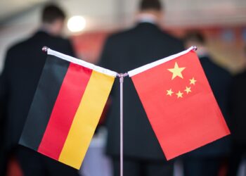 FILED - A Chinese and a German flag stand at a reception. Photo: Ole Spata/dpa