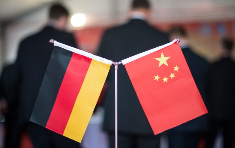 FILED - A Chinese and a German flag stand at a reception. Photo: Ole Spata/dpa