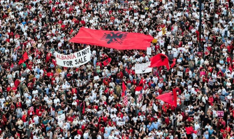 A drone view shows protesters gathered outside the Prime Minister's Office in Tirana, Albania, on June 10, 2026, during the tenth consecutive day of demonstrations against a proposed luxury tourism development project linked to Jared Kushner. Organizers say thousands of people attend the rally. (Photo by Vlasov Sulaj/NurPhoto via Getty Images)