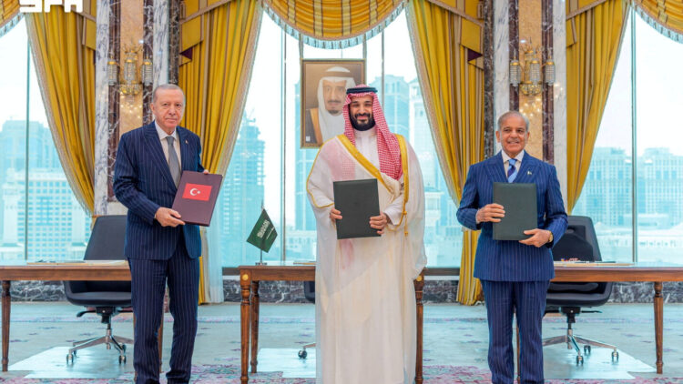 Turkish President Tayyip Erdogan, Saudi Crown Prince Mohammed bin Salman, and Pakistan's Prime Minister Shehbaz Sharif pose after signing a joint defence agreement in Mecca, Saudi Arabia, August 7, 2026. Saudi Press Agency/Handout via REUTERS