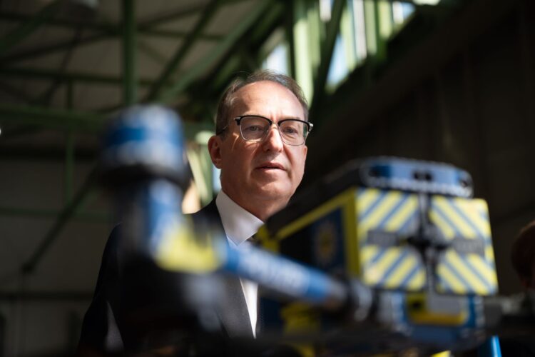 Alexander Dobrindt, German Minister of the Interior, inspects a helicopter belonging to the Federal Police Air Squadron in Fuldatal inside a maintenance hangar. During his summer tour, Dobrindt is visiting various law enforcement agencies in Thuringia and Hesse. Photo: Katharina Kausche/dpa-Pool/dpa