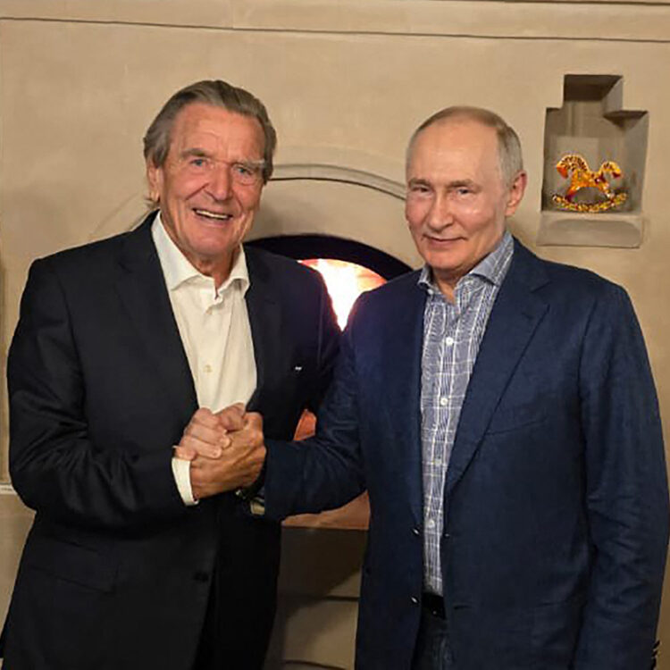 This handout photograph posted on @news_kremlin, the Telegram channel of the Russian presidential press office, on October 8, 2026, shows Russia's President Vladimir Putin and former German chancellor Gerhard Schroeder shaking hands during the celebration of the Russian leader's 74th birthday at an undisclosed location. (Photo by Handout / RUSSIAN PRESIDENTIAL PRESS OFFICE / AFP) / RESTRICTED TO EDITORIAL USE - MANDATORY CREDIT "AFP PHOTO / Russian presidential press office" - HANDOUT - NO MARKETING NO ADVERTISING CAMPAIGNS - DISTRIBUTED AS A SERVICE TO CLIENTS
